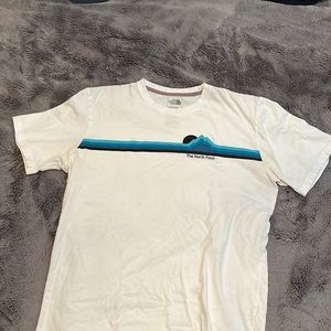 The North Face, large white tee with graphics on front.